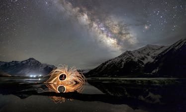 Breathtaking night sky over Zanskar with Milky Way and light art reflection.
